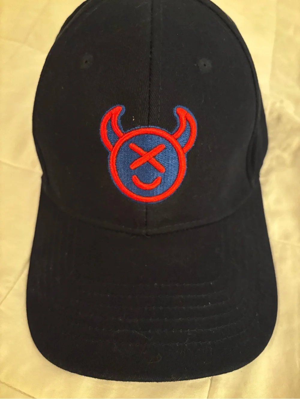 Source Unknown Black Cap with Red & Blue Devil Emblem